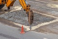 Road works using a hydraulic hammer. Repair of asphalt road Royalty Free Stock Photo