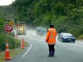 Road works: woman worker with stop sign and cars