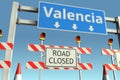 Roadblock near Valencia city road sign. Coronavirus disease quarantine or lockdown conceptual 3D rendering