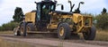 Roadgrader smoothing a dirt road. Royalty Free Stock Photo