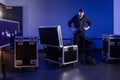 Roadie standing next to an unpacked flightcase Royalty Free Stock Photo