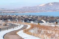 Roads and homes in peaceful neighborhood with scenic views of mountain and lake