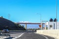 Roadside bathroom on Athens to Corinth Highway Greece with snow-covered mountains of Peloponnese in the distance and a cloud of