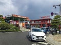 Roadside food court with beautiful landscaping and parked cars