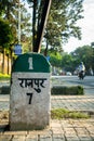 Roadside milestone displaying distance to Rajpur town on Rajpur Road