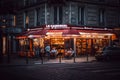 Roadside restaurant "Le Cardinal" with tourists in the evening in Paris, France