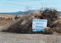 Roadside sign in the tumbleweeds Royalty Free Stock Photo