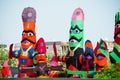 roadside streetside shot of huge paper mache effigies puppets of demon ravana being built in colorful paper to be burnt