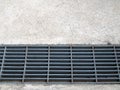 roadside manhole drain sewer closed with gray cover steel gratings Royalty Free Stock Photo