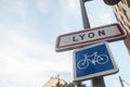 Roadsign indicating the entrance to Lyon with a bicycle sign. This sign is a standard French plate visible at every city entrance