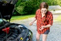 Roadtrip preparation checking motor oil dipstick Royalty Free Stock Photo