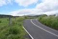 Roadway through a green hilly ranch along the Road to Hana on the island of Maui, Hawaii Royalty Free Stock Photo