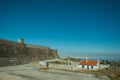 Roadway next to rustic house and dam wall Royalty Free Stock Photo