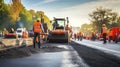 Roadwork in Action - The Busy Scene of Workers and Machinery at a Highway Construction Site Laying Asphalt