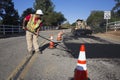 Roadworker repaves road with steam, Encino Drive, Oak View, California, USA