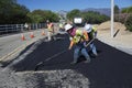 Roadworkers repaves road with steam, Encino Drive, Oak View, California, USA