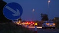 Roadworks cones flashing on UK motorway at night with traffic passing Royalty Free Stock Photo