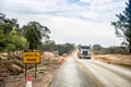 Roadworks with Gravel road sign and 40 km h speed limit sign in Australia