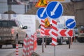 Roadworks warning traffic signs of construction work on city street and slowly moving cars Royalty Free Stock Photo