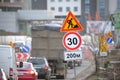 Roadworks warning traffic signs of construction work on city street and slowly moving cars Royalty Free Stock Photo