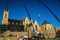 A Two Cranes Raising a Restored Steeple at Saint AndrewÃ¢â¬â¢s Catholic Church