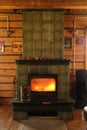 Roaring fire inside wood burning stove in the old wooden house village, vintage house Royalty Free Stock Photo