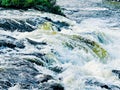 Roaring water cascade on a river bend Royalty Free Stock Photo