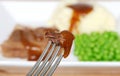 Roast beef and gravy on a fork Royalty Free Stock Photo