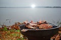 Roast beef on a hot stove in the morning with heavy fog, River Royalty Free Stock Photo