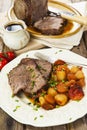 Roast beef joint with roast vegetables Royalty Free Stock Photo