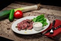 Roast beef with lettuce and garlic sauce, fresh cucumber and tomato. On a rustic wooden background Royalty Free Stock Photo