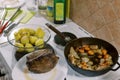 Roast beef lies on a plate next to a pan with vegetables and a bowl of potatoes Royalty Free Stock Photo