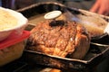 Roast beef with meat thermometer next to prepped mashed potatoes