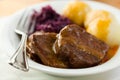 Roast beef with potato dumplings and red cabbage Royalty Free Stock Photo