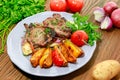 Roast beef rib eye flato with pita bread, tomato, potato veggies, onion and coriander served in dish isolated on table side view Royalty Free Stock Photo