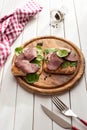 Roast beef sandwich with salad and pepper on rustic wooden plate. Royalty Free Stock Photo