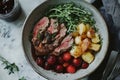 Roast beef served with roasted potatoes, cranberries, and fresh thyme Royalty Free Stock Photo