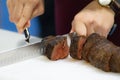 Roast beef and slice, chef `s hands cutting roast beef, Carving roast beef Royalty Free Stock Photo