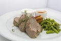 Roast beef and yorkshire pudding with baked green beans Royalty Free Stock Photo