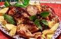 A roast chicken on a bed of roast potatoes