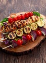 Roast Chicken filet kebab with cherry grilled on BBQ. tomatoes, zucchini and red onions on bamboo sticks Royalty Free Stock Photo