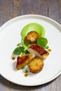 Roast chicken with fondant potatoes, pea mousse, pea puree, garlic flowers and nasturtium leaves Royalty Free Stock Photo