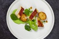 Roast chicken with fondant potatoes, pea mousse, pea puree, garlic flowers and nasturtium leaves Royalty Free Stock Photo