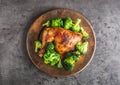 Roast chicken Leg. Chicken roasted leg with broccoli on concrete