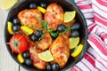 Roast chicken with lemon, olives, tomatoes and thyme. Dinner Royalty Free Stock Photo