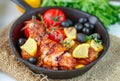 Roast chicken with lemon, olives, tomatoes and thyme. Dinner Royalty Free Stock Photo