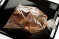 Roast chicken into a oven bag Royalty Free Stock Photo