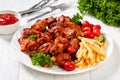 Roast chicken wings with french fries and veggies Royalty Free Stock Photo