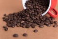 Roast coffee beans and vintage red cup on wood background Royalty Free Stock Photo