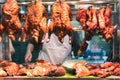 Roast crispy Chinese duck and pork hanging from market stall window of a street food vendor Royalty Free Stock Photo